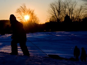 Tobogganers take advantage of a sunny snow covered Mount-Royal Park in Montreal