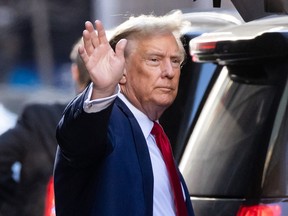 Former U.S. president Donald Trump waves as he departs Trump Tower on his way to New York Supreme Court in New York City on Feb. 15, 2024.