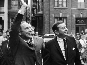 Pierre Trudeau waves to supporters as he enters Liberal Party campaign headquarters in Ottawa, Tuesday, June 25, 1968.