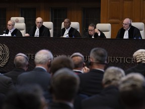 The United Nations' highest court with presiding judge Nawaf Salam, left, opening historic hearings in The Hague, Netherlands, Monday, Feb. 19, 2024.
