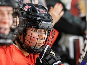 Amanda Boulier sits on the bench with a helmet on