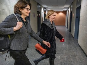 Luce Julien, right, head of news at Radio Canada, leaves courtroom with Radio Canada reporter Josée Dupuis during a break in a defamation lawsuit by 42 Suréte du Québec officers from the Val d'Or detachment brought against Radio Canada and Dupuis, at the Palais de Justice in Montreal on Feb. 7, 2024.