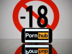 Photo shows a cellphone screen displaying the logo of the pornographic site Pornhub.