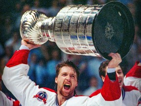 Canadiens goalie Patrick Roy hoists the Stanley Cup after the Habs defeated the Kings in the 1993 finals.