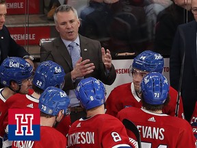Montreal Canadiens players face Martin St. Louis as he gives instructions from the team's bench