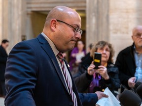 English Montreal School Board chair Joe Ortona looks dejected as he speaks to reporters outside a courthouse.