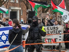 Jewish and pro-Palestinian groups hold rival protests outside a synagogue, waving flags and holding placards.