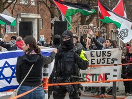 Jewish and pro-Palestinian groups hold rival protests outside a synagogue, waving flags and holding placards.