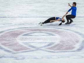 Two people figure skate near the Canadiens' C on at the Bell Centre.