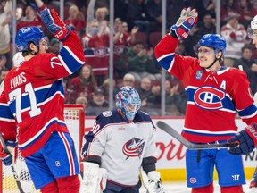 Canadiens' Brendan Gallagher high-fives Jake Evans, left after scoring a goal only 21 seconds into the game against the Blue Jackets at the Bell Centre Tuesday night.