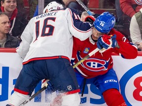 Blue Jackets' Brendan Gaunce leans his elbow into the upper body of Canadiens' Johnathan Kovacevic Tuesday night at the Bell Centre.