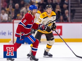 A Montreal Canadien skates in front of a Boston Bruin during a hockey game