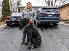 Charlotte Gibson is seen with her service dog, Onyx, in her home driveway in Dollard-des-Ormeaux on Monday, March 18, 2024.