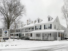 A white inn in the snow.