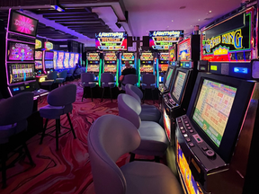 Interior view of a casino, with rows of video slot machines
