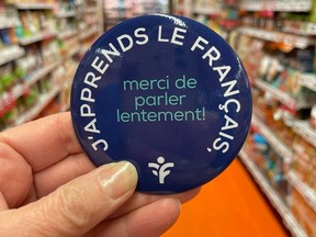 Photo from Provigo (Boucherville) Facebook page shows button some employees wear, with the words, in French: "I'm learning French; thanks for speaking slowly!"