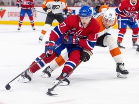 Canadiens' Josh Anderson shields the puck from Philadelphia Flyers defenceman Adam Ginning