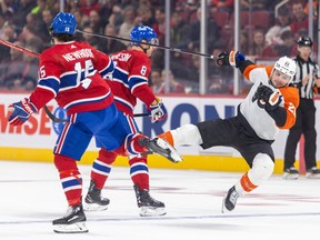 Scott Laughton falls to the side between two Canadiens players
