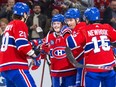 Canadiens players embrace on the ice