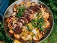 Roasted cauliflower and pork tenderloin in a frying pan.