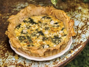 A wilted greens tart on a white plate.