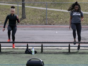 Two women exercise in a park.