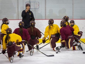 Concordia Stingers women's hockey head coach Julie Chu speaks to her players on the ice during practice