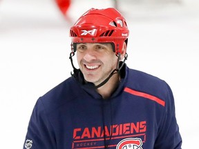 Joel Bouchard smiles while wearing a helmet during practice