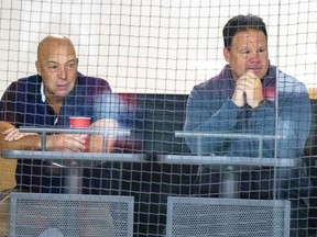 Canadiens general manager Kent Hughes, left, and executive vice president of hockey operations Jeff Gorton watch rookie camp in Brossard last September.