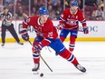 Canadiens' Juraj Slafkovsky skates the puck into the Boston Bruins zone trailed by linemate Nick Suzuki in Montreal on March 14, 2024.