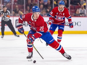 Canadiens' Juraj Slafkovsky skates the puck into the Boston Bruins zone trailed by linemate Nick Suzuki in Montreal on March 14, 2024.