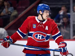 Canadiens' Brendan Gallagher seen holding his stick across his waist.