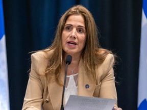 Pascale Déry speaks while sitting at a table in front of a microphone