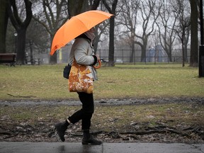 A woman walks with her umbrella in Montreal.