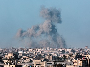 This picture taken from Rafah shows smoke billowing over Khan Yunis in the southern Gaza Strip during Israeli bombardment on March 1, 2024, amid continuing battles between Israel and the Palestinian militant group Hamas.