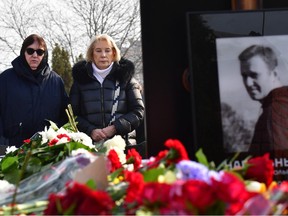 Lyudmila Navalnaya (the woman wearing glasses), mother of late Russian opposition leader Alexei Navalny, accompanied by Alla, mother of Navalny's widow, Yulia, visits the grave of her son at the Borisovo cemetery in Moscow on Saturday, March 2, 2024, the next day after Navalny's funeral.