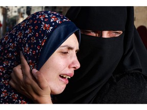 Rania Abu Anza, left, the mother of twin babies Naeem and Wissam, killed in an overnight Israeli air strike, mourns their death ahead of their burial in Rafah in the southern Gaza Strip on Sunday, March 3, 2024, as the conflict between Israel and the Palestinian militant group Hamas continues.