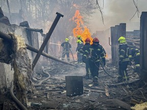 This handout photograph taken and released by Ukrainian Emergency Service on March 15, 2024 shows rescuers extinguishing a fire at the site of a missile attack in Odesa.