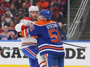 Canadiens' Joshua Roy is checked by Oilers' Troy Stecher in third period of game at Rogers Place in Edmonton Tuesday night.