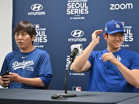 Dodgers' Shohei Ohtani, right, and his interpreter Ippei Mizuhara attend a press conference at Gocheok Sky Dome in Seoul.