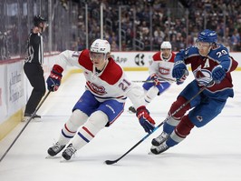 Montreal Canadien Kaiden Guhle skates past a Colorado Avalanche player