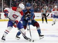 Two hockey players go for the puck.