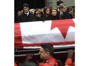 Mila Mulroney and her daughter Caroline watch as the casket of former prime minister Brian Mulroney is taken away at Notre-Dame Basilica in Montreal on Saturday, March 23, 2024.