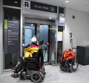 Two commuters in wheelchairs wait for the elevator for the REM at Central Station on Friday, Feb. 16, 2024.