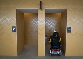 Commuter in wheelchair tries to negotiate the tight entrance of the washroom at the RTL's South Shore terminus on Friday, Feb. 16, 2024.