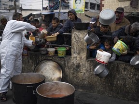 Palestinians line up for free food in Rafah, Gaza Strip, Feb. 23, 2024.