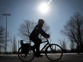 Cyclist enjoys to spring sun as he makes is way along the REV on Bellechasse near Lanaudierre on Wednesday March 22, 2023.