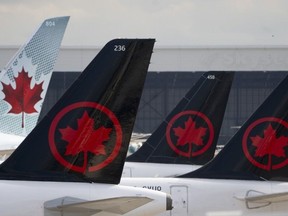 Air Canada logos are seen on the tails of planes at the airport in Montreal on Monday, June 26, 2023.