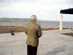 Brian Mulroney, seen from behind, looks out over the sea