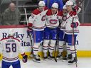 Canadiens defenceman David Savard heads over to congratulate centre Nick Suzuki, second from left, after his goal against the Avalanche Tuesday night in Colorado. Congratulating Suzuki are, from left, defenceman Arber Xhekaj, wingers Cole Caufield and Juraj Slafkovsky.